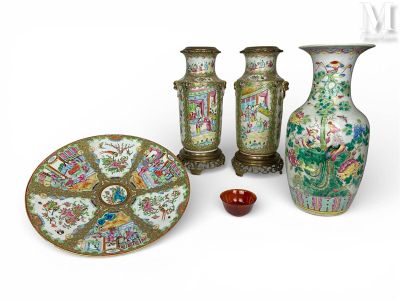 three vases and a plate sitting next to each other