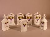 cinq petits vases blancs ornés de fleurs violettes