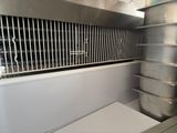 a large stainless steel oven with a lot of pots and pans
