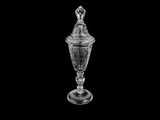 an image of a clear glass vase with a lid on a black background