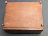 an old wooden box sitting on top of a table