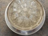a silver plate with a flower design on it on a table