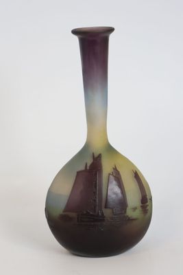 a vase with a sailboat on it on a white surface