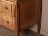 a wooden dresser with a vase on top of it
