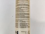 a bottle of body lotion sitting on a white surface