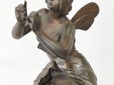 a statue of a woman sitting on top of a table