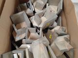 a cardboard box full of wood pieces in a room
