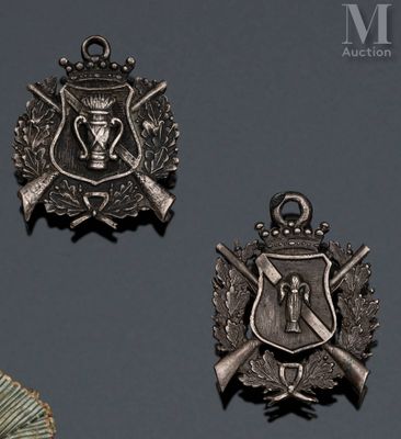 three medals are displayed on a gray surface with a black background