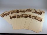 an old photo of a bunch of old postcards sitting on top of a table
