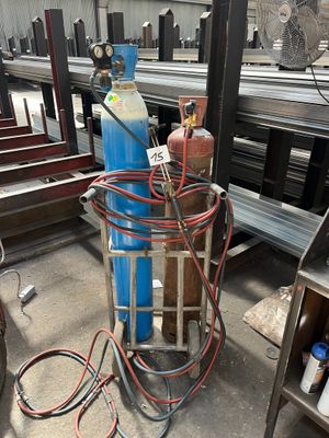 a large blue tank sitting on top of a metal cart