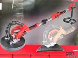 a box with a red and black tool and a pair of scissors on it