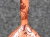 a brown vase with a floral design on it