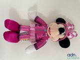 minnie mouse plush toy laying down on a white surface