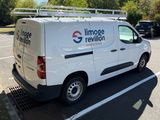 a white van that is parked in a parking lot