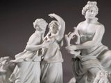 a statue of a man and a woman playing a musical instrument