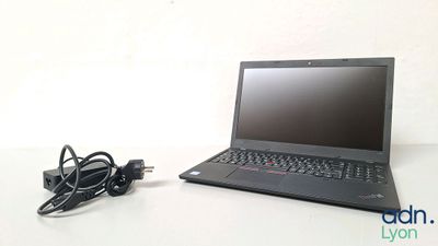 a laptop that is sitting on a table with a charger