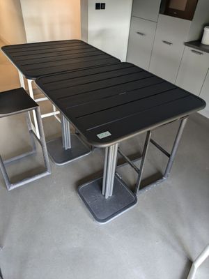 une table noire et deux chaises dans une cuisine