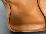 the inside of a brown leather purse with a zipper on it