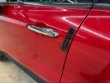 a close up of a car door handle with a sticker on it
