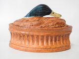 a duck that is sitting on top of a bowl
