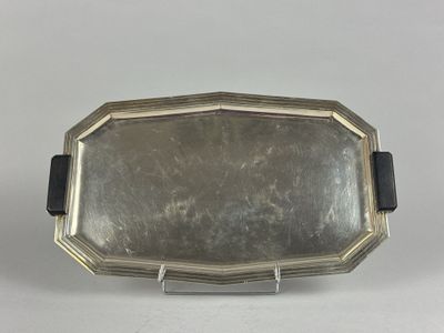 an antique silver plate with a black handle and a black band
