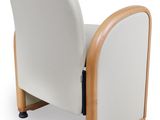 the back of a white chair with wooden legs and a white seat