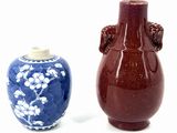 two vases sitting next to each other on a white surface