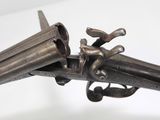 a gun that is on display on a white surface