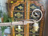 a small wooden cabinet with a metal object on top of it
