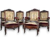 four chairs with red velvet upholstered seats and a picture on the back of them