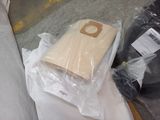 a bag of wood sitting on the floor next to a bag of wood