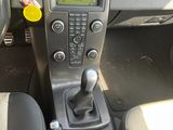 a car dashboard with a remote control and a sticker on it