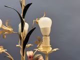 a light that is on a pole with flowers on it