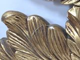 a close up of a gold leaf decoration on a wall