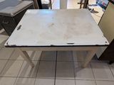 a white table with a black top in a kitchen