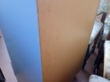 a blue cabinet sitting on the floor next to a chair