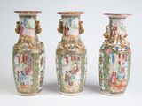 three vases sitting side by side on a white surface