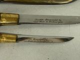 three knives that are sitting on a table