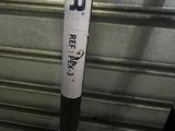 a baseball bat that is on the ground in front of a garage door