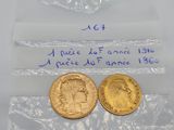 two gold coins in plastic bags on a table