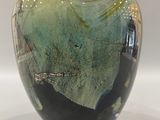 a glass vase that is sitting on a table