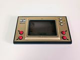 a close up of a small game console on a white surface