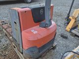 a forklift sitting on top of a pallet in a parking lot