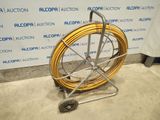 an image of a hose on a cart in front of a wall