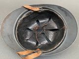 a metal bowl with a leather band around it