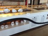 a long counter with bowls and bowls on it