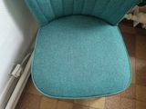 a blue chair that has been cleaned and is sitting on the floor