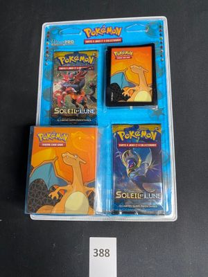 three pokemon trading cards in a plastic case on a table
