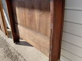a wooden headboard on the side of a building
