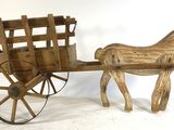 a wooden horse pulling a wagon with a wooden seat